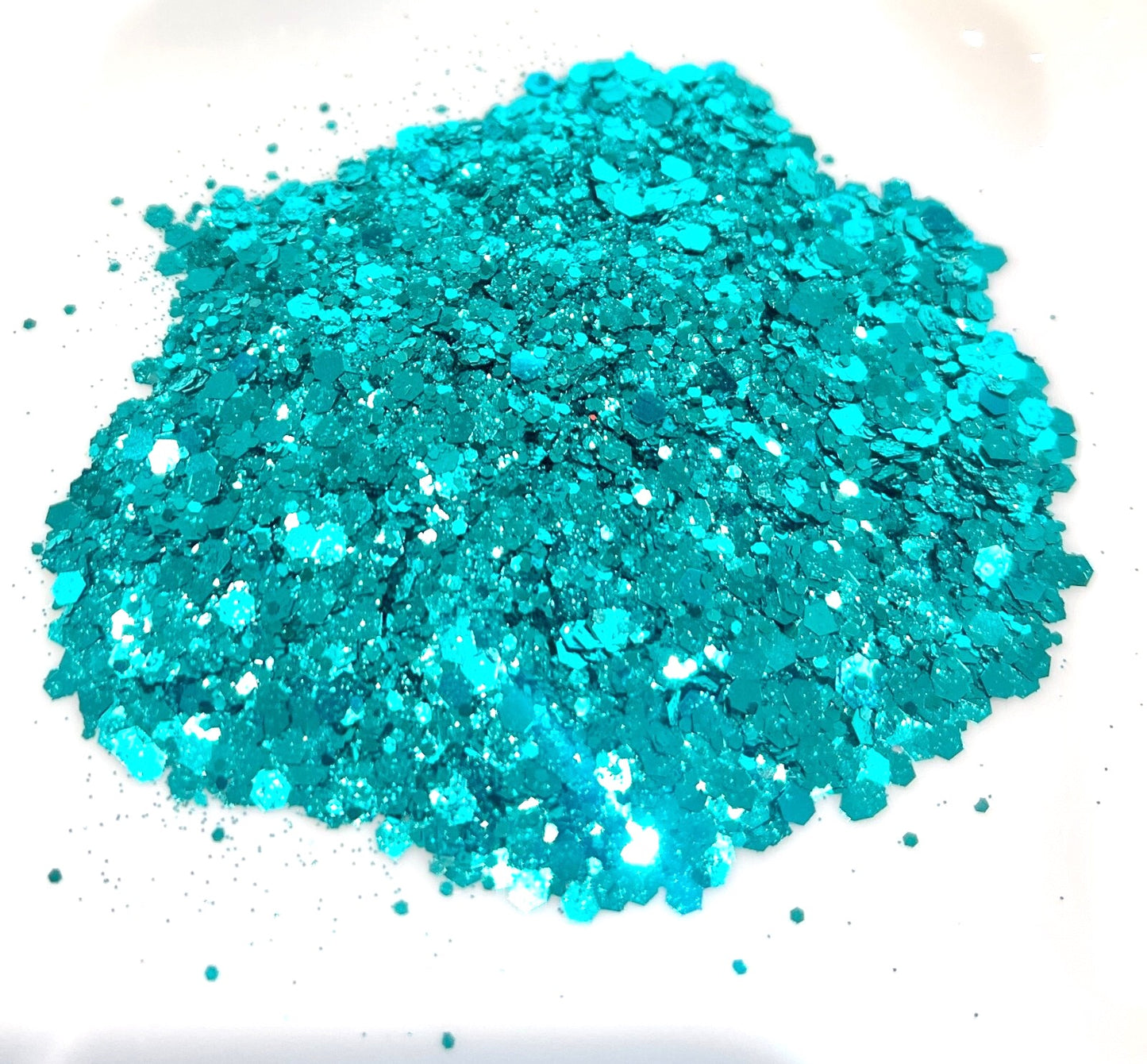 Turquoise glitter on a white background