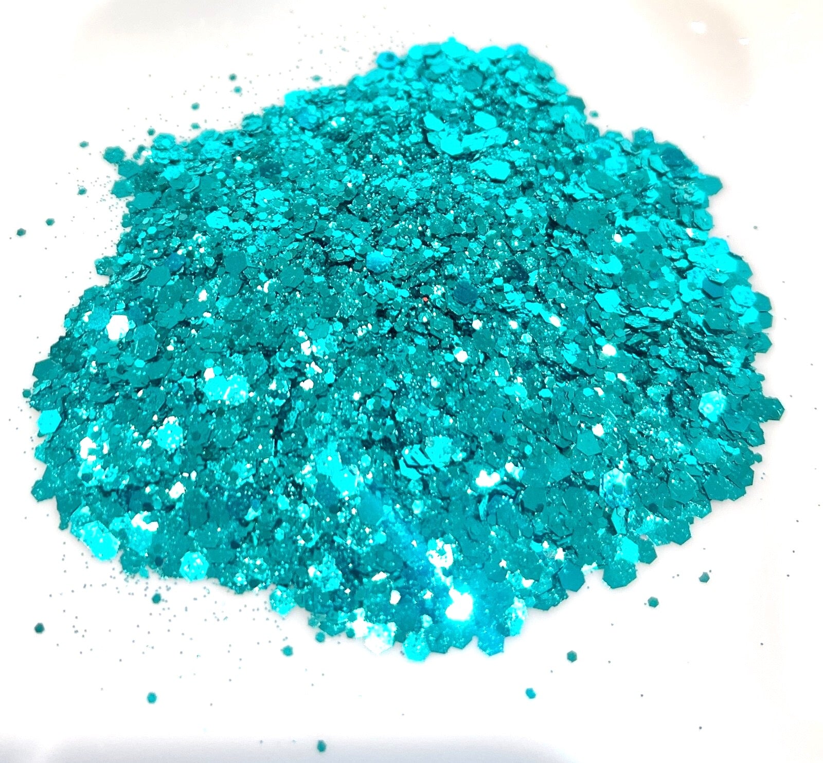 Turquoise glitter on a white background