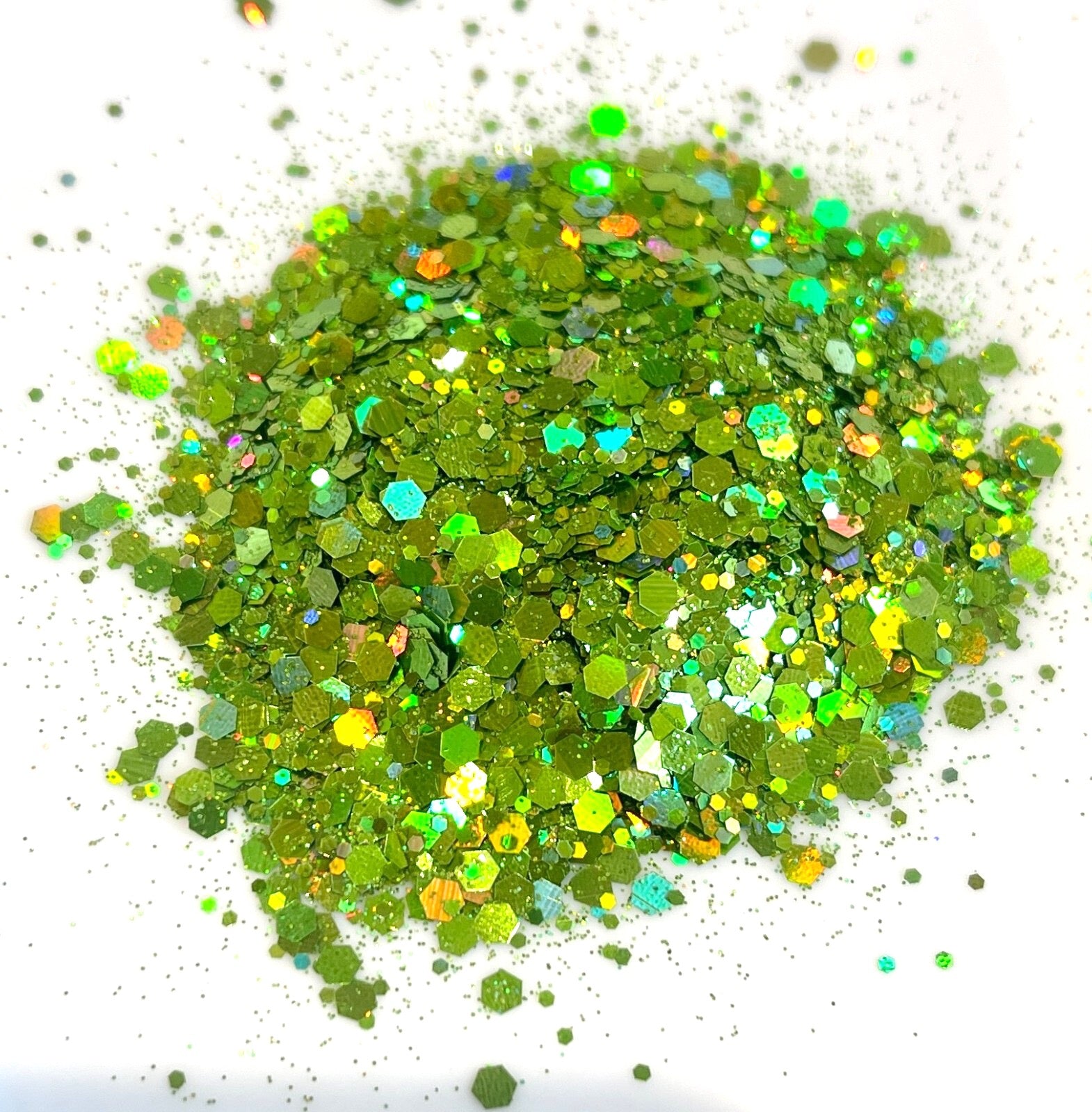Green holographic glitter on a white background