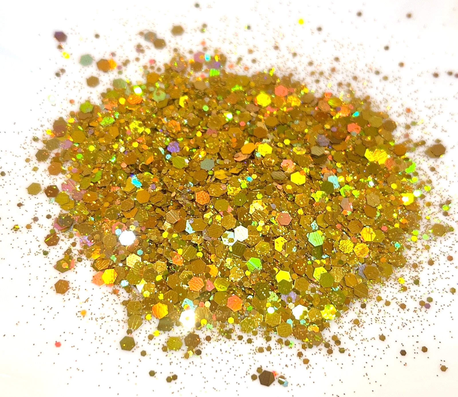 Gold coloured glitter on a white background